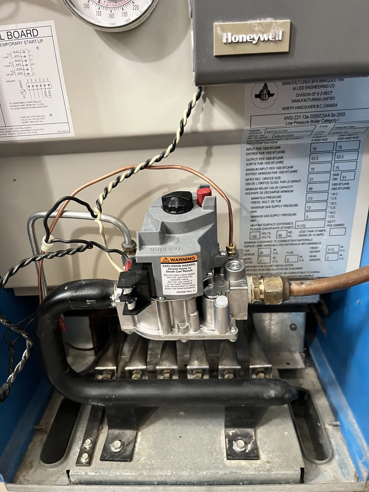 Gas valve and burner assembly on the older boiler photographed during the Burnaby service call